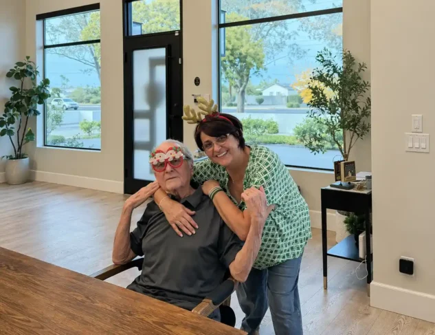 Senior resident smiling with caregiver during a cheerful moment inside Torbrook Assisted Living community in Scottsdale, Arizona