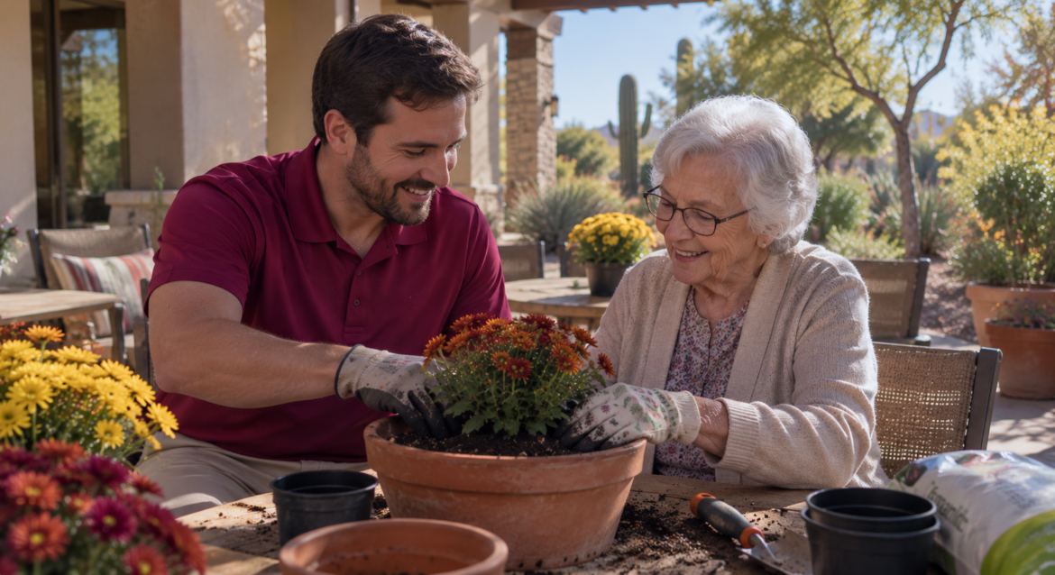 autumn-senior-wellness-activities-in-scottsdale Compassionate caregiver wearing a deep fuchsia shirt assisting an elderly resident while potting autumn flowers in a sunlit Scottsdale courtyard, showcasing autumn senior wellness activities in scottsdale.